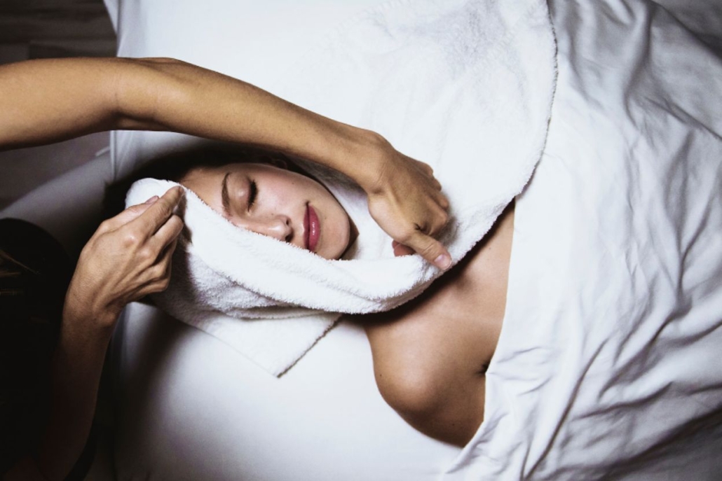 A woman enjoying a facial treatment at a tranquil spa, highlighting self-care and wellness in a soothing atmosphere.