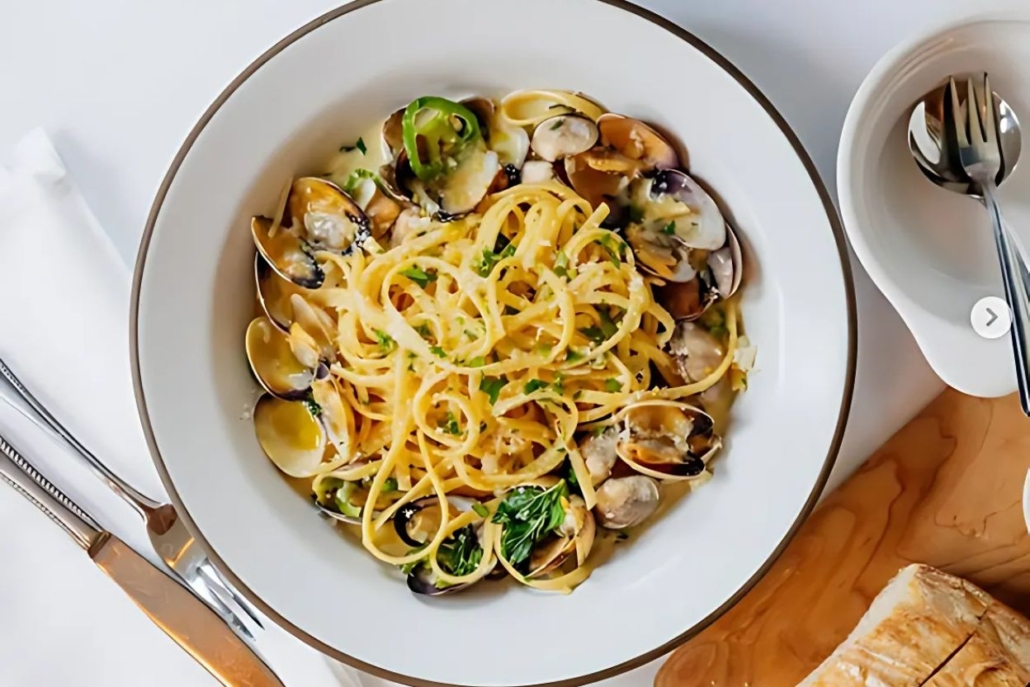 A delicious plate of pasta with clams and bread, cooked by Clark’s Oyster Bar in Aspen during February.