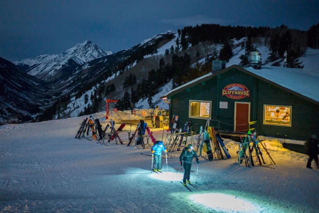 A group of people enjoys the night skiing after dinner at Cliff House in Aspen, February.