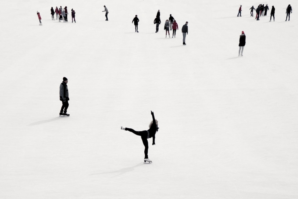 A Ice Skater skillfully performs a trick, capturing the thrill of winter sports in a snowy environment.