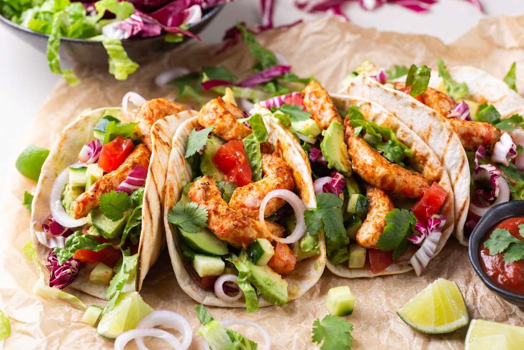 Tacos filled with lobster, fresh vegetables, and lime, set against a backdrop of Aspen trees in February.
