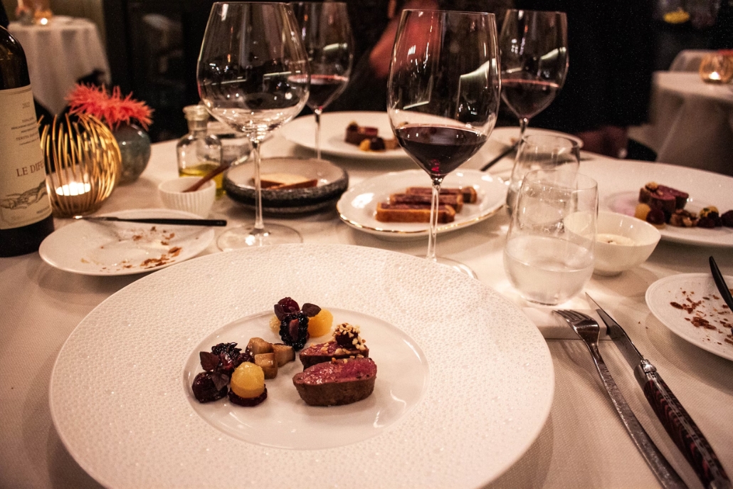 A beautifully arranged table with various food plates and wine glasses, situated at Element 47 in Aspen, February.