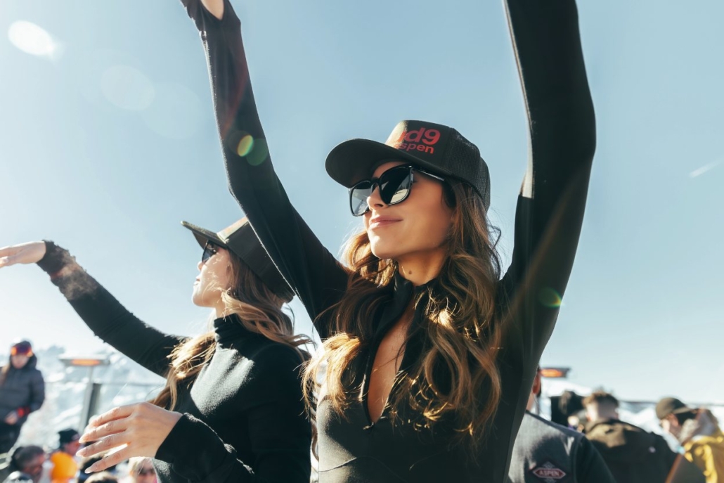 Guests enjoying the vibrant après-ski scene at Cloud Nine Alpine Bistro, soaking up the sunshine and energy of Aspen in February.