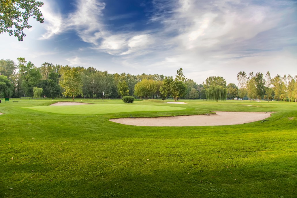 An expansive golf course in Aspen, showcasing green grass and trees, set within the Ranch at Roaring Fork.