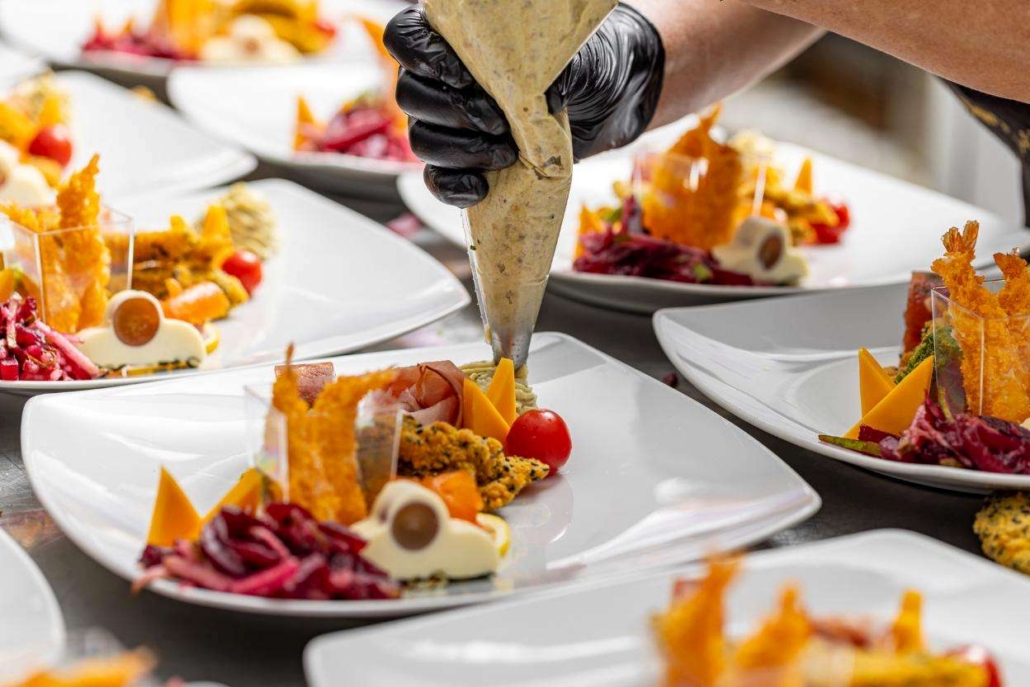 Aspen private chef preparing gourmet plates with luxury catering presentation