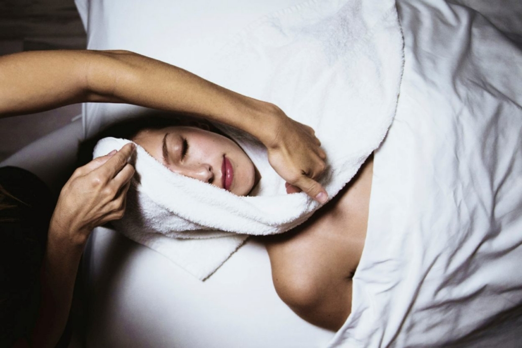 A woman receives a calming facial massage in a serene Aspen spa, enhancing her relaxation and rejuvenation experience in May.