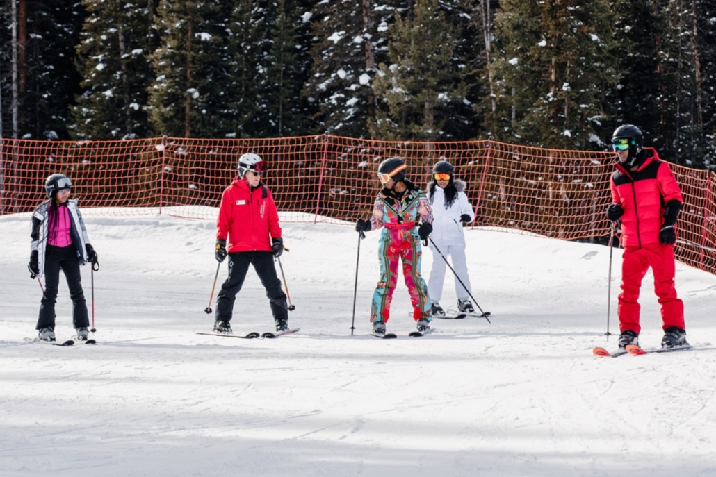 Family ski lesson in Aspen Colorado during a winter family vacation with kids learning to ski on beginner slopes