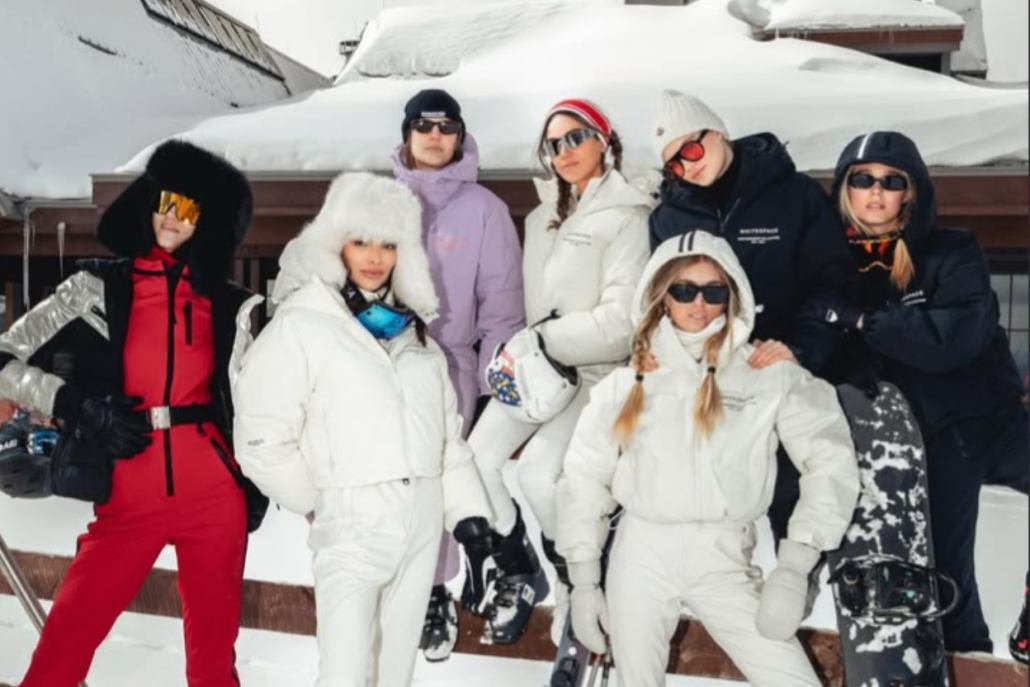 A cheerful group of friends in ski attire posing for a photo at the Snow Lodge during an Aspen bachelorette celebration.