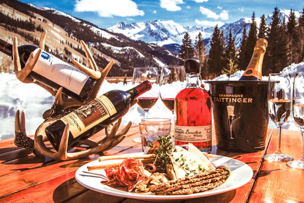 A table set with wine and various dishes, showcasing a festive lunch at Pine Creek Cookhouse during an Aspen bachelorette party.