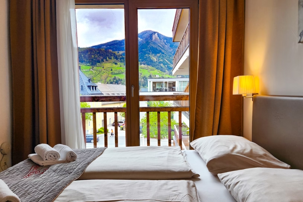 Stylish bedroom showcasing a bed and panoramic mountain views, part of The Ritz Carlton, Aspen Bachelorette.
