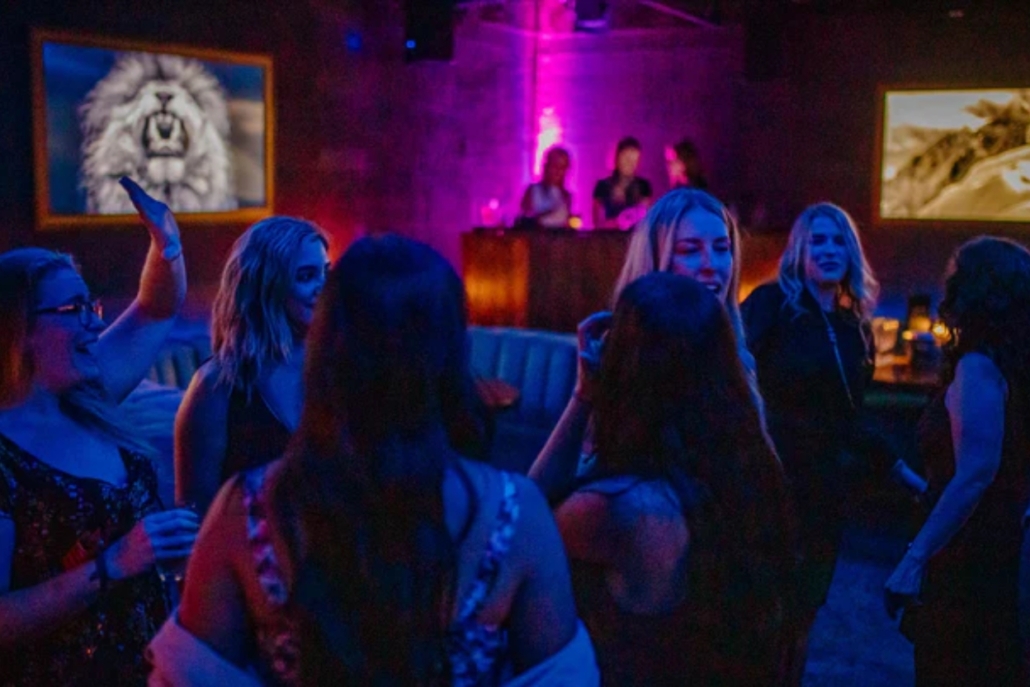 A lively group of people dancing joyfully at The Sterling, showcasing their bachelorette party in Aspen