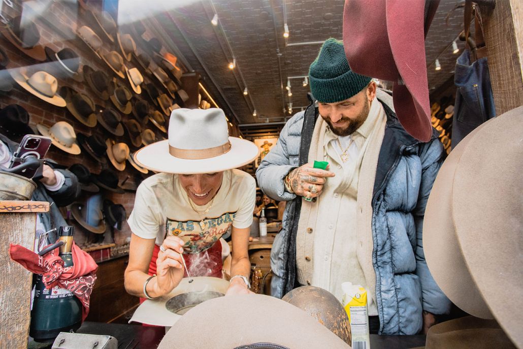 Inside Kemo Sabe Aspen, a man in a beanie has a custom hat designed, perfect for Aspen Style.