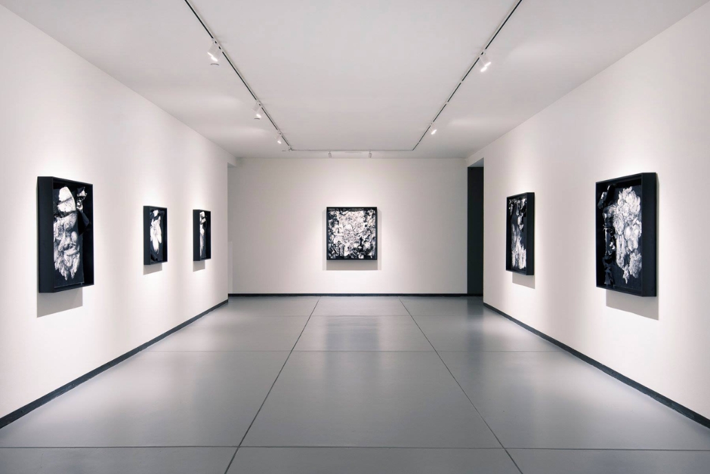 Interior of Baldwin Gallery showcasing black and white paintings, highlighting Aspen Summer Activities in art.