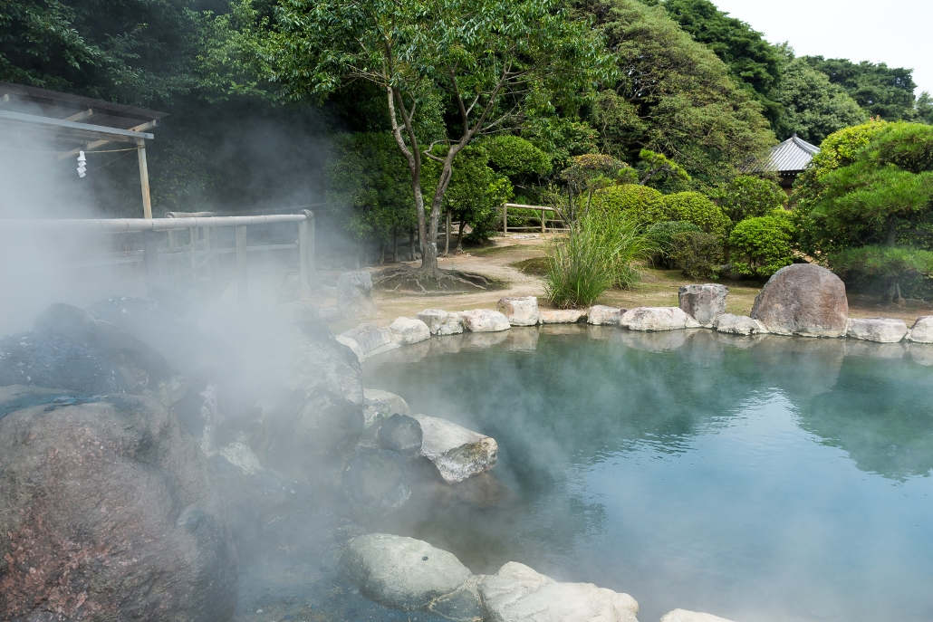 A picturesque hot spring emitting steam, highlighting a popular summer attraction in Aspen.