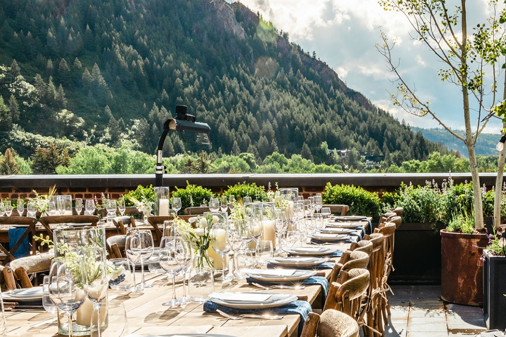 An outdoor dining area in Aspen, featuring elegant decoration with stunning mountain views in the background.