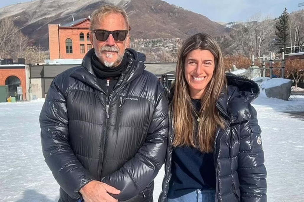 Kevin Costner, pose in the snow with stunning mountains behind them in Aspen