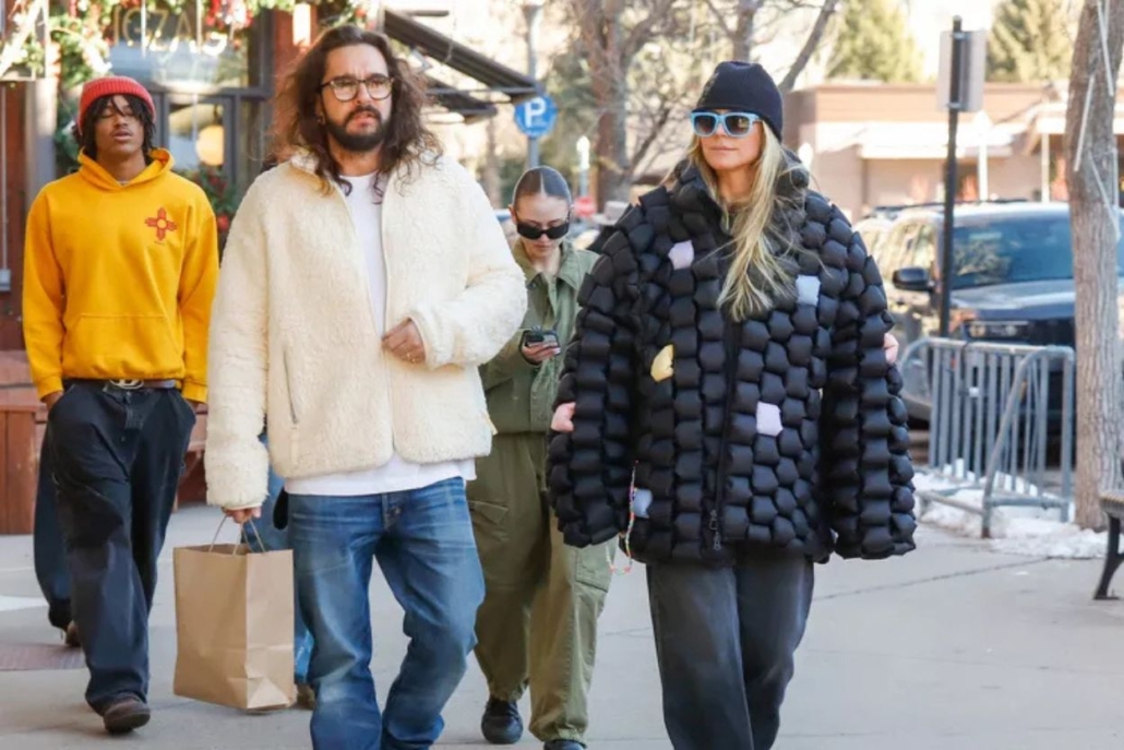 Heidi Klum and a man stroll down a bustling city street, enjoying their time together.