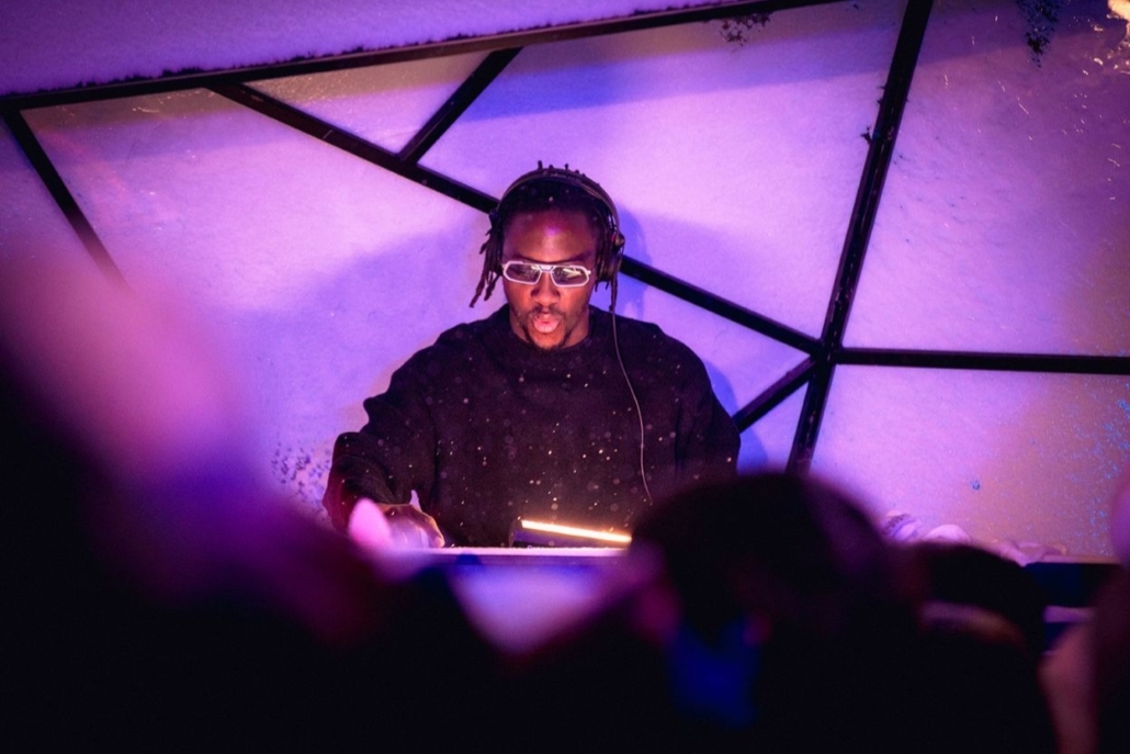 DJ spinning live under neon lights at an exclusive nightclub, setting the vibe for a high-energy nightlife experience.