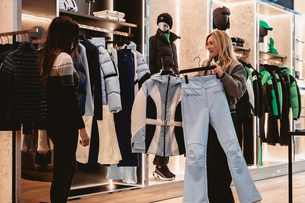 A woman browses luxury clothing in a store during a vibrant fall day in downtown Aspen.