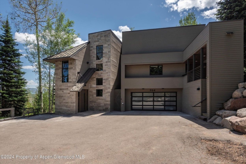 Modern mountain home exterior with stone façade and garage at Faraway Escape in Snowmass.