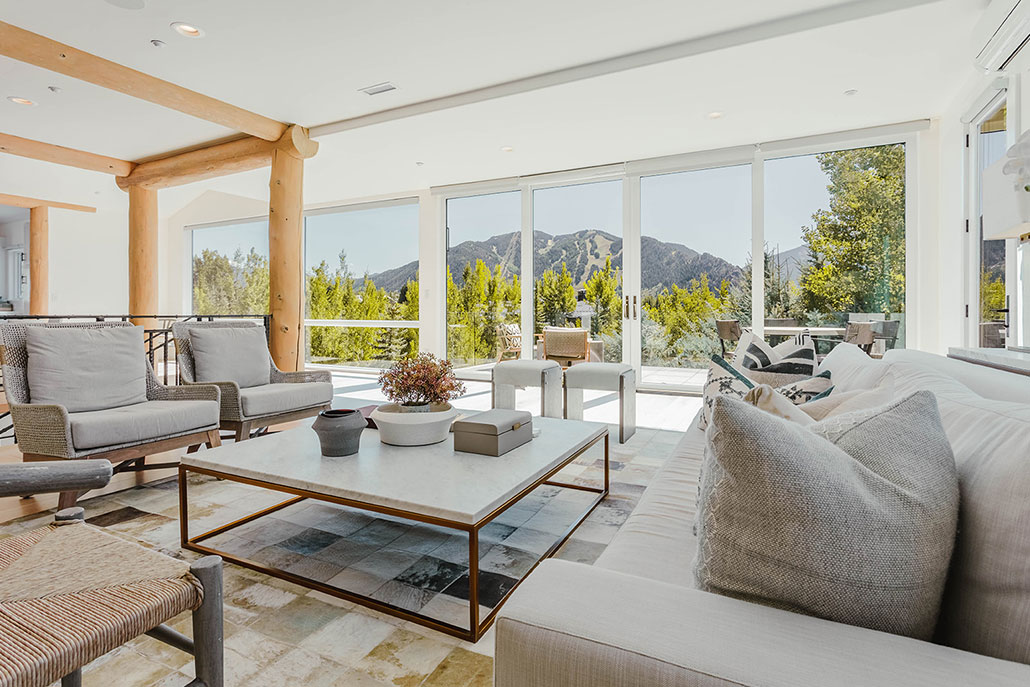 A bright living room overlooking Aspen, ideal for a romantic Aspen honeymoon stay.