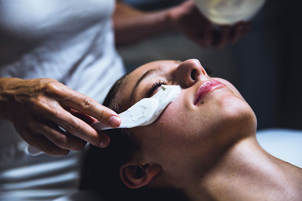 Woman getting a relaxing spa facial while on her honeymoon in Aspen.