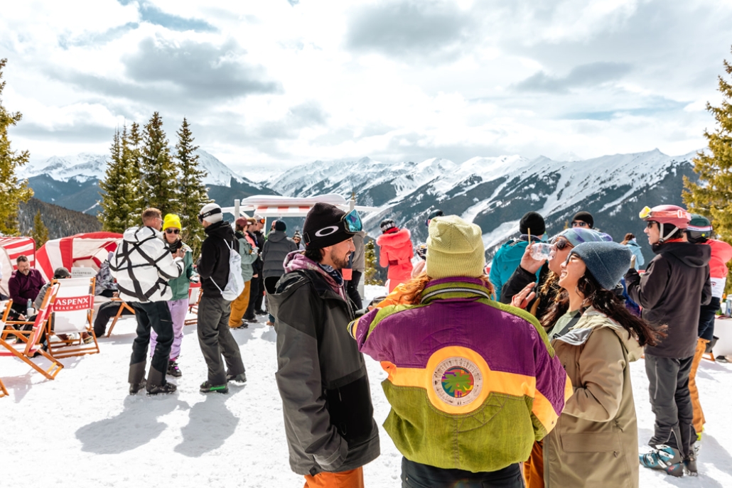 A lively group of individuals on a snowy slope in Aspen, embodying the festive spirit of the après ski scene.