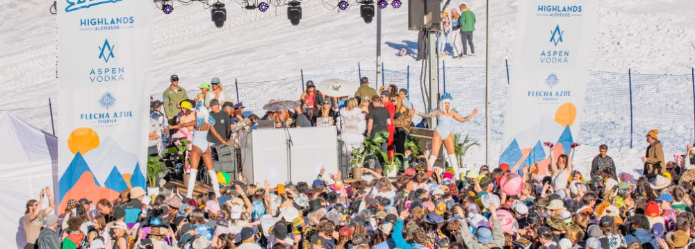 A lively crowd gathers at Aspen ski resort, enjoying the festive atmosphere of the party scene.