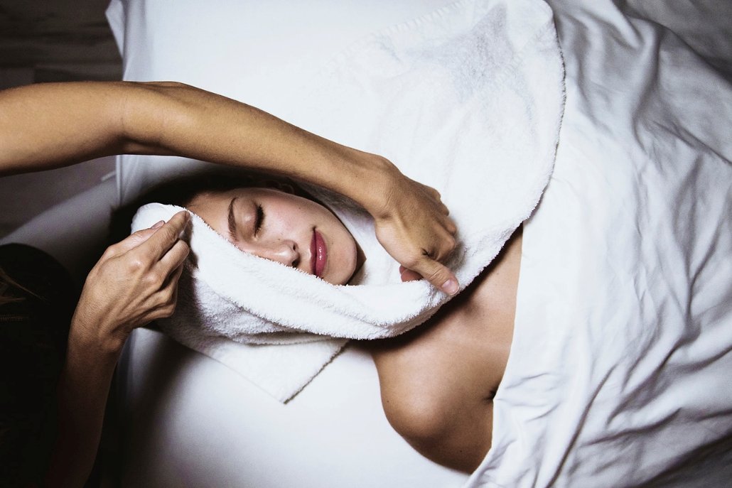 A woman enjoys a relaxing facial massage at a spa, promoting wellness during her Aspen getaway.