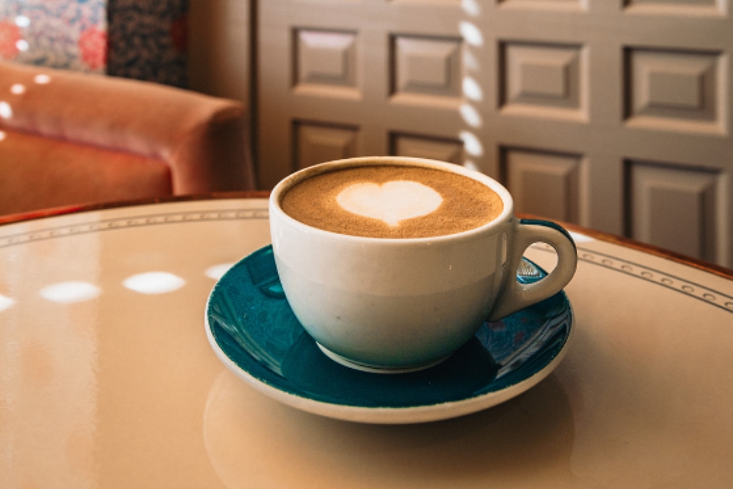 A cup of coffee topped with a heart shape, highlighting local coffee shops in Aspen beyond skiing activities.