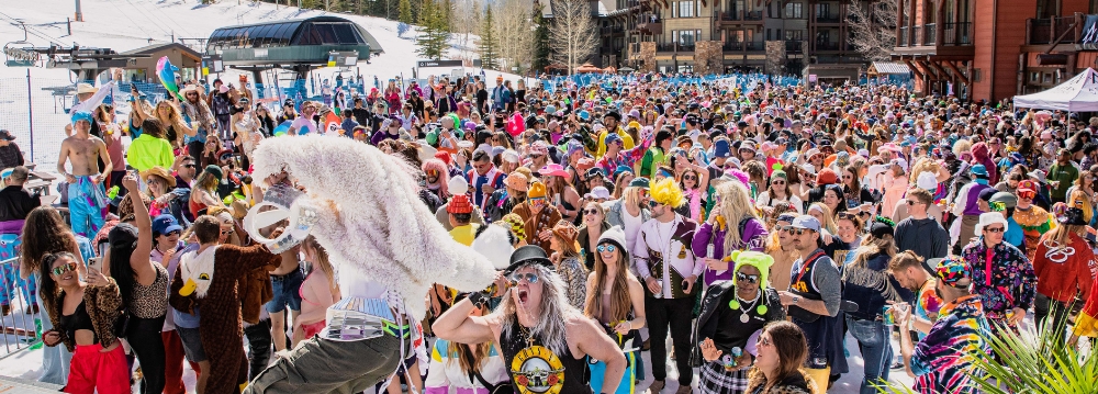 A lively crowd gathers at a ski resort in Aspen, Colorado, enjoying the spring break atmosphere.