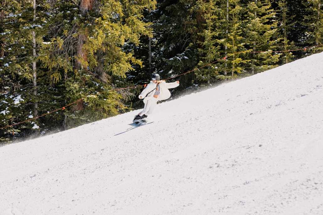 A snowboarder glides down a snowy slope during Aspen, Colorado's Spring Break ski and snowboard season.