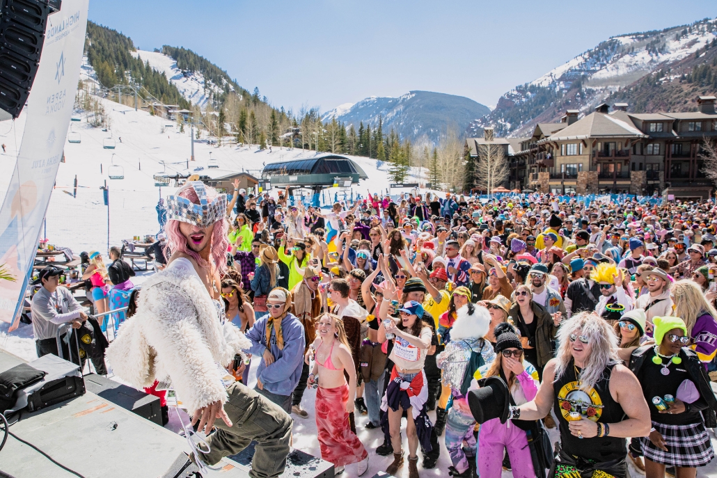 A lively group of people skiing and socializing at a winter resort in Aspen, showcasing the vibrant winter sports scene.