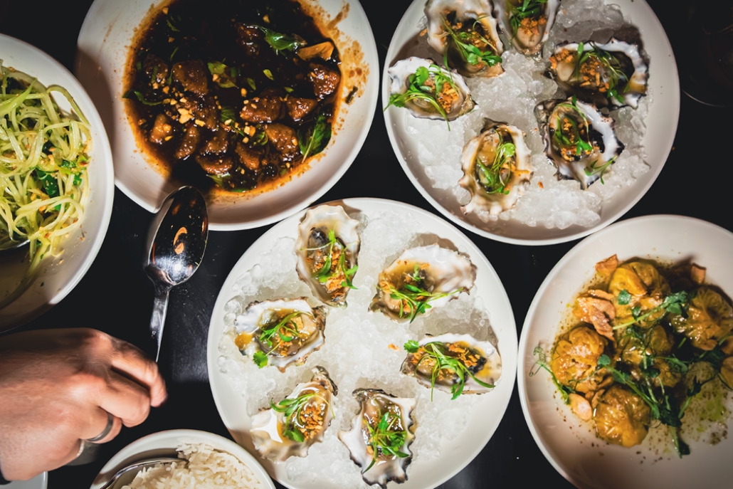 A dining table displaying an assortment of dishes, highlighted in the Aspen Travel Guide for best eateries.