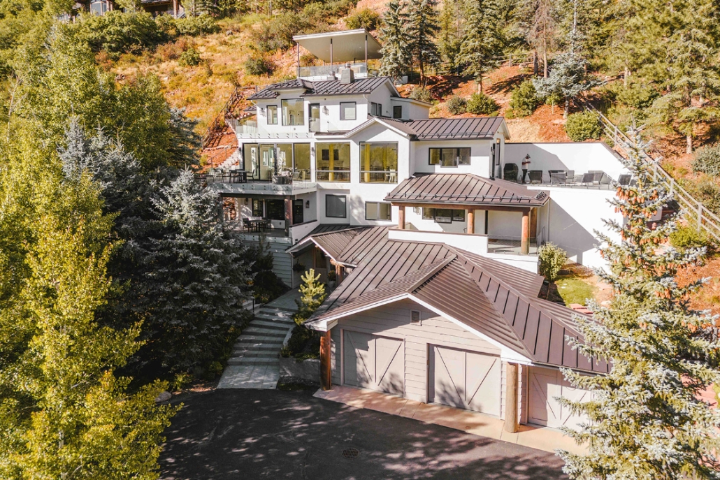 A spacious home featuring a large driveway and garage, highlighted in the Aspen Travel Guide
