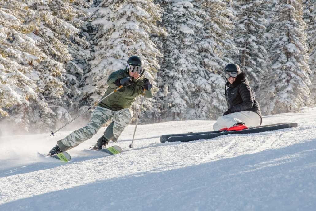 Two skiers navigate a snowy slope in Aspen, showcasing the excitement of skiing at Snowmass.