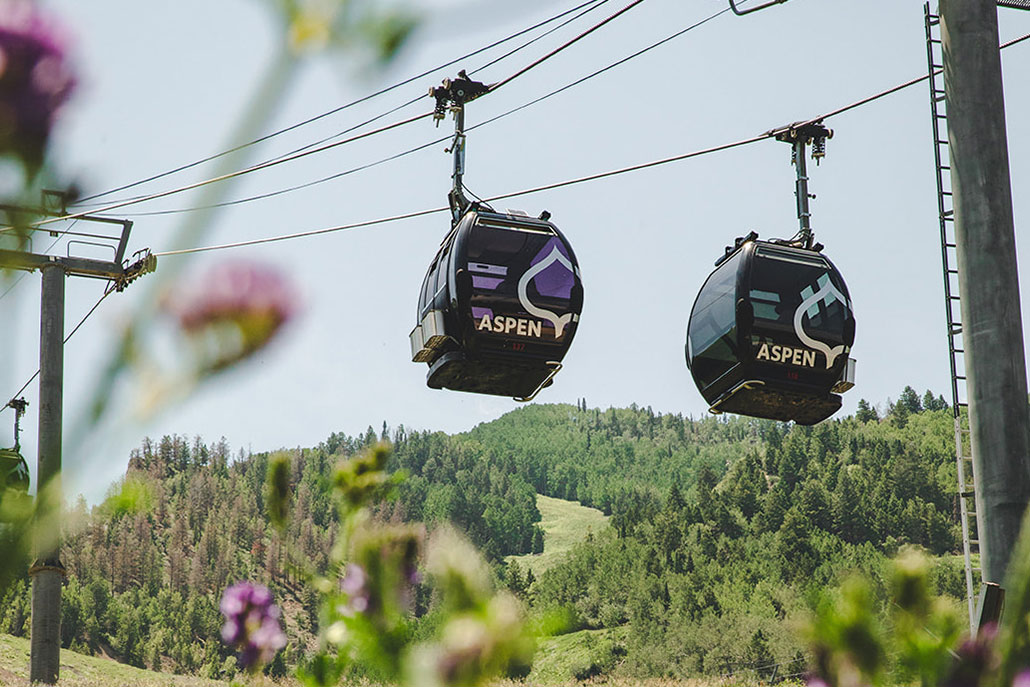 Aspen gondola ride over scenic mountains during a summer family vacation with panoramic views in Colorado