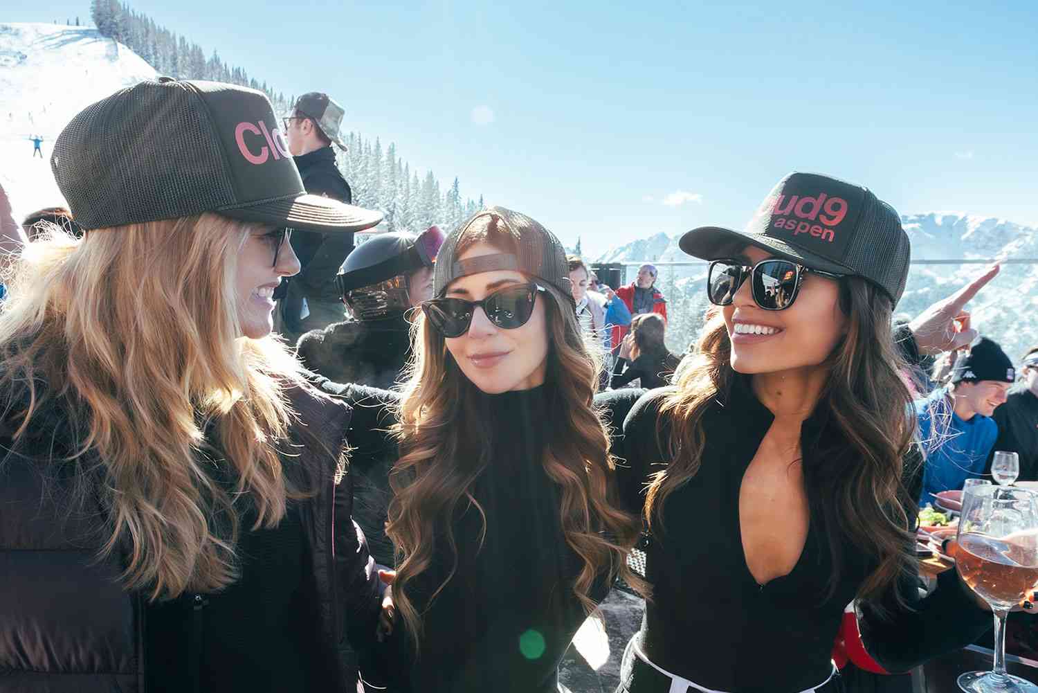 celebrating-in-aspen Luxury après-ski party in Aspen with stylish guests enjoying mountain views and drinks