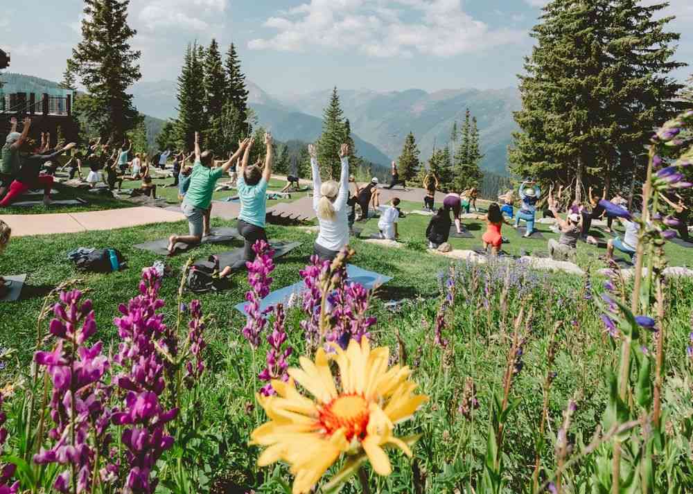 Summer-Travel-in-Aspen-i Outdoor yoga session with scenic mountain views during summer in Aspen