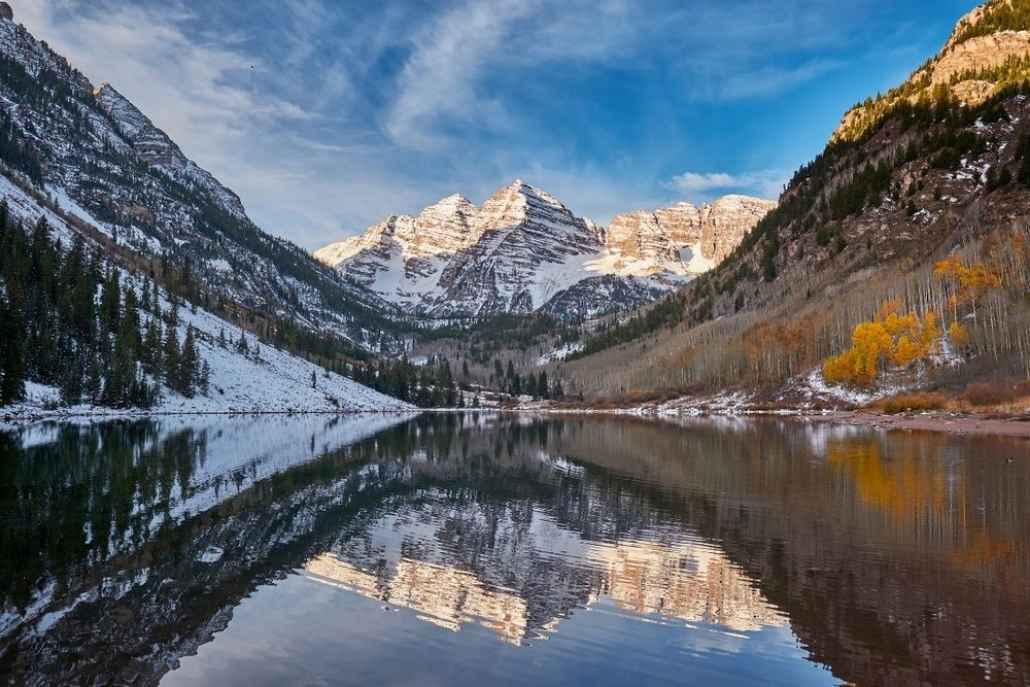 Scenic view of Maroon Bells reflecting on a pristine alpine lake near Aspen