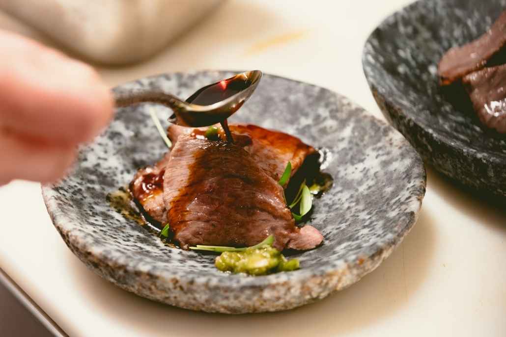 Luxury private chef plating a gourmet steak entrée for an exclusive dining experience in Aspen
