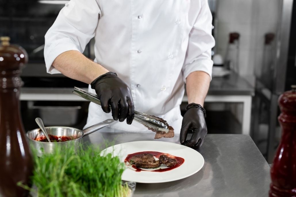 Private chef plating a gourmet meal for an Aspen luxury stay after guests settle in