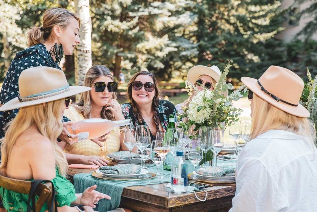 First-time Aspen travelers enjoying an elegant outdoor lunch with friends