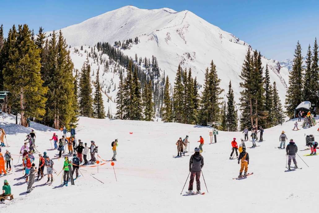 Winter skiing at Aspen Mountain with snowy peaks and visitors
