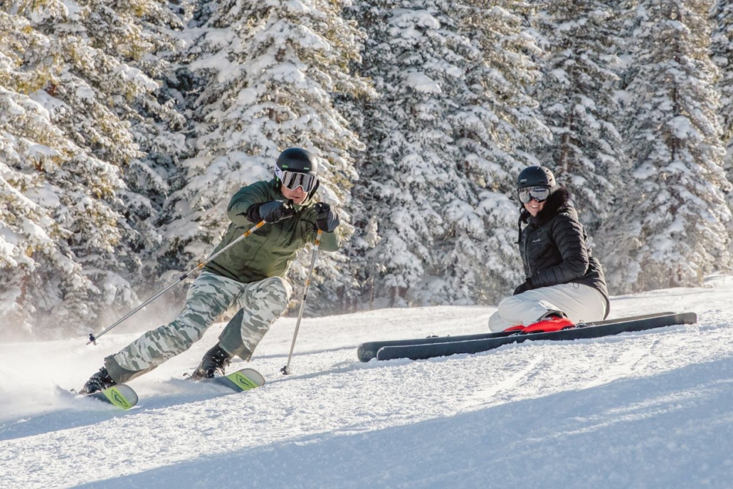 Skiers enjoying a private mountain guide experience on a snowy Aspen slope